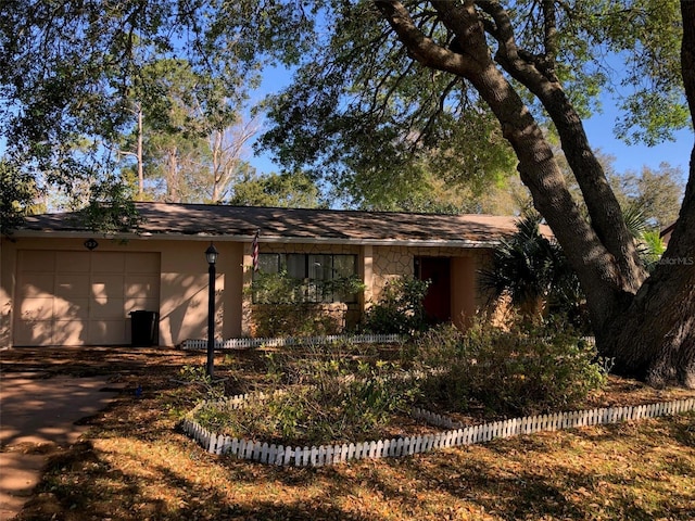 view of front of home with stucco siding and a garage