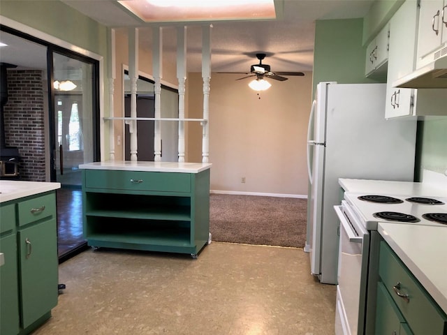 kitchen featuring a ceiling fan, a wood stove, light countertops, green cabinets, and white range with electric stovetop