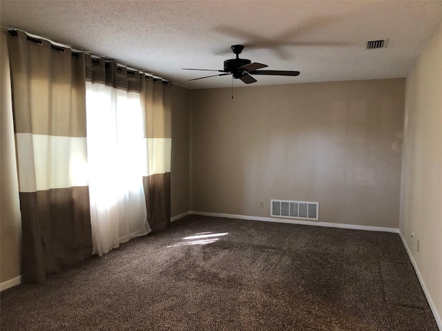 unfurnished room featuring ceiling fan, carpet flooring, visible vents, and a textured ceiling