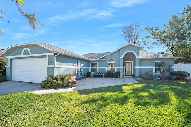 ranch-style house featuring a garage, concrete driveway, a front lawn, and stucco siding