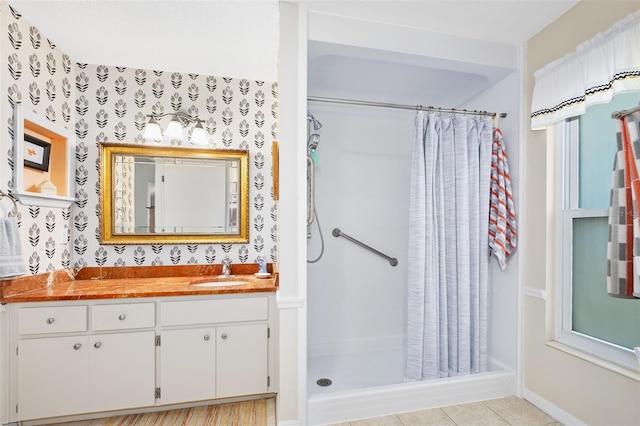 bathroom with a shower with shower curtain, tile patterned floors, vanity, and wallpapered walls