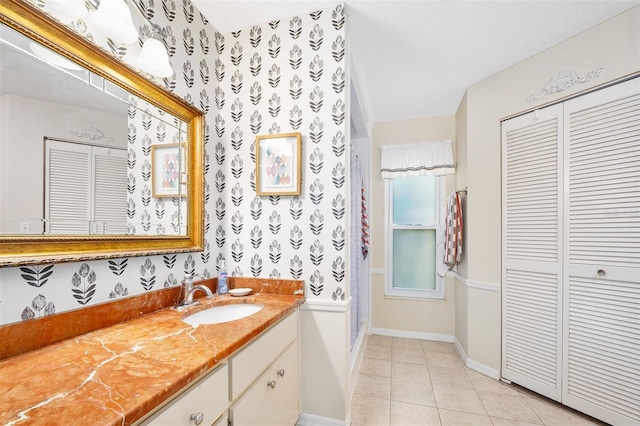 full bath featuring wallpapered walls, baseboards, a closet, and tile patterned flooring