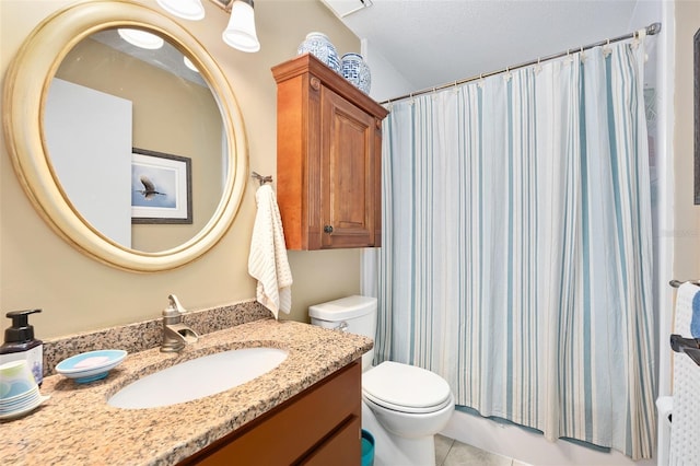 bathroom with tile patterned flooring, toilet, a textured ceiling, and vanity