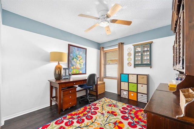 office space with baseboards, a textured ceiling, dark wood finished floors, and a ceiling fan