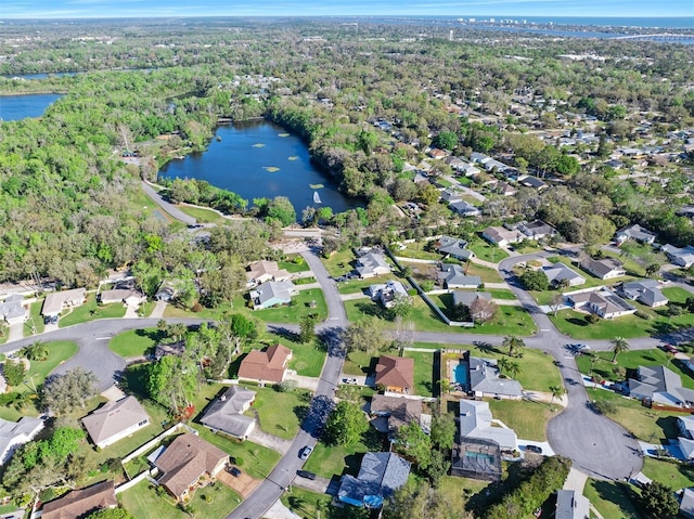 birds eye view of property with a residential view, a forest view, and a water view