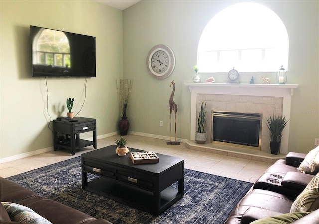 living room featuring tile patterned flooring, a fireplace, and baseboards