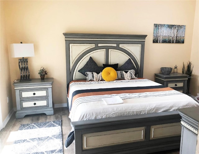 bedroom with wood finished floors and baseboards