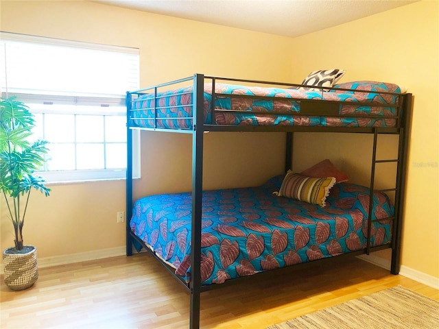 bedroom featuring baseboards and wood finished floors