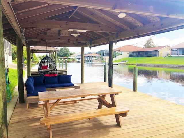 view of dock with a residential view and a water view