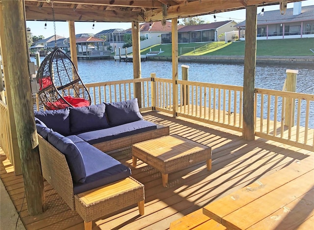 dock area featuring an outdoor living space, a residential view, and a water view