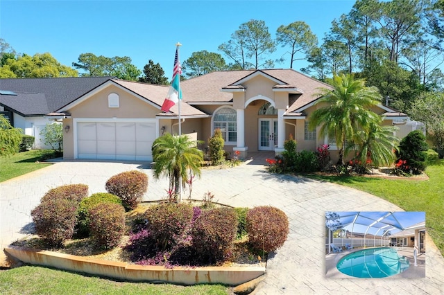 view of front of property featuring a shingled roof, stucco siding, french doors, a garage, and driveway