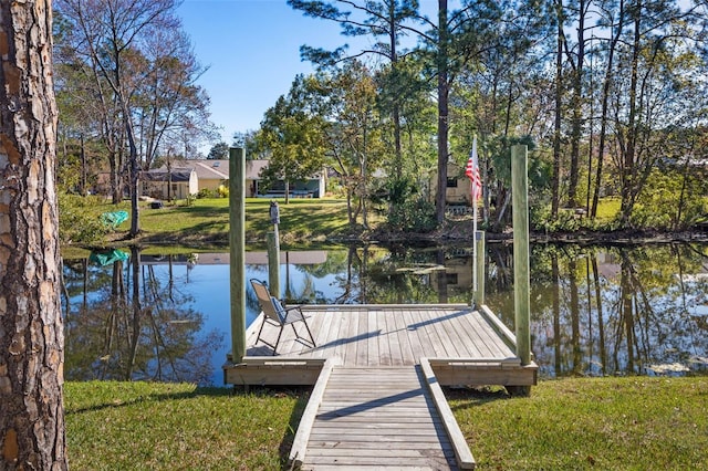 dock area featuring a yard and a water view