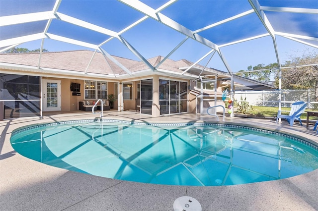 view of swimming pool with a fenced in pool, fence, a lanai, and a patio area