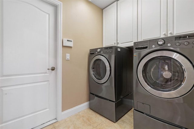 laundry room with light tile patterned floors, cabinet space, and independent washer and dryer