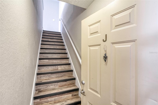 stairway with a textured wall