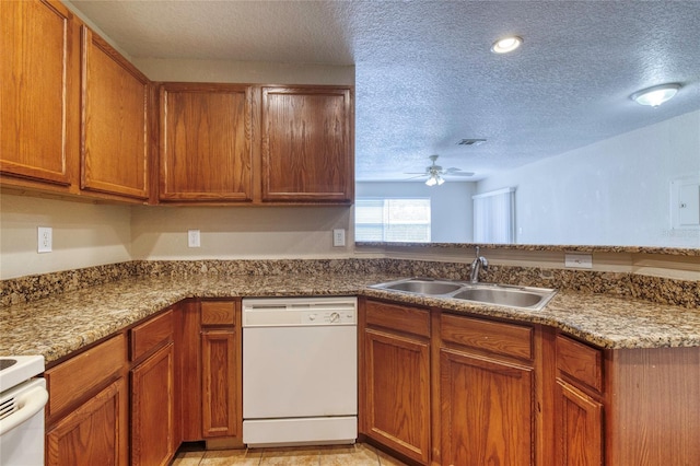 kitchen with a sink, brown cabinets, a ceiling fan, and white dishwasher