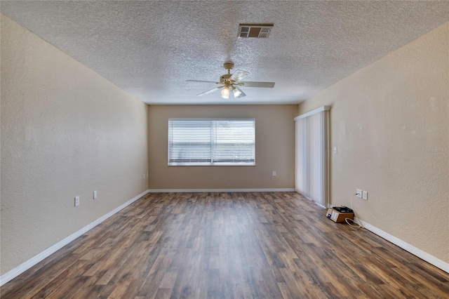 unfurnished room featuring visible vents, baseboards, ceiling fan, dark wood-style flooring, and a textured wall