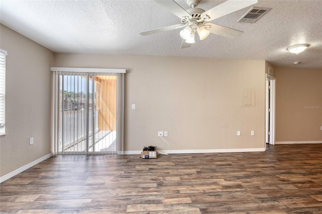 spare room with visible vents, baseboards, and wood finished floors