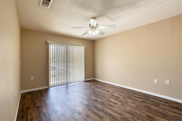 unfurnished room with visible vents, dark wood-type flooring, a ceiling fan, baseboards, and a textured wall