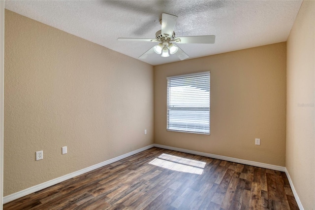 unfurnished room featuring dark wood-type flooring, a ceiling fan, a textured ceiling, baseboards, and a textured wall