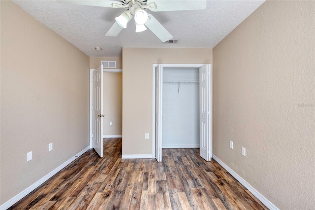 unfurnished bedroom with wood finished floors, visible vents, and baseboards