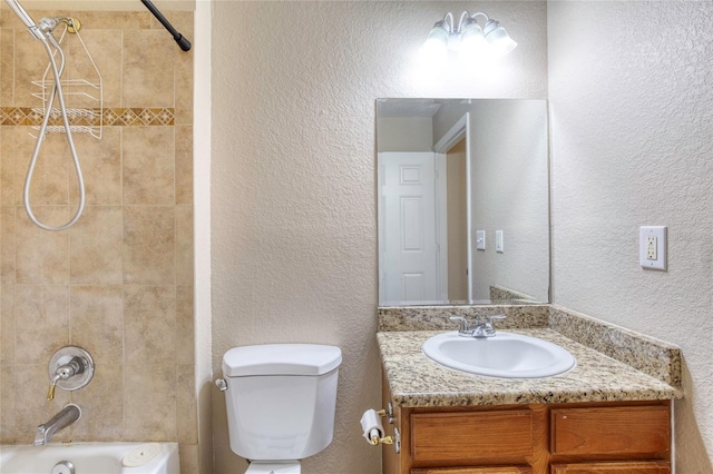 bathroom featuring vanity, toilet, a textured wall, and tub / shower combination