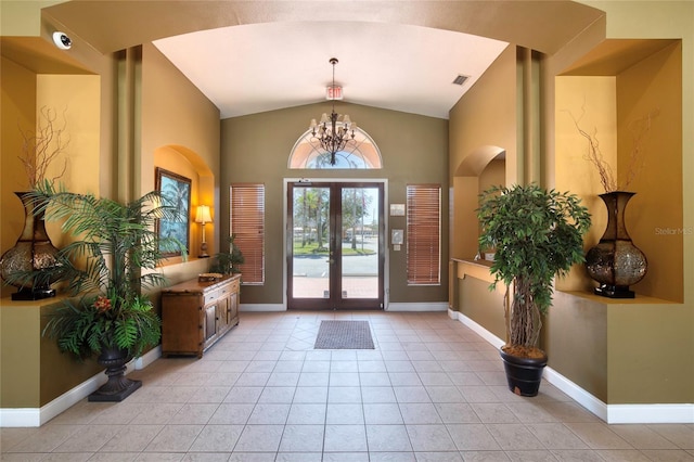 entrance foyer featuring baseboards, visible vents, an inviting chandelier, lofted ceiling, and french doors