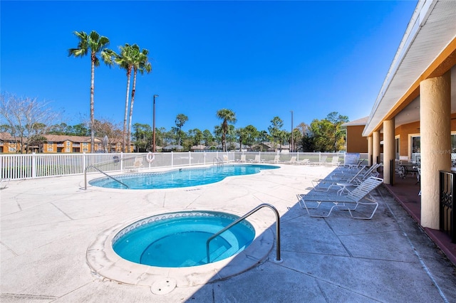 pool featuring a patio, a community hot tub, and fence