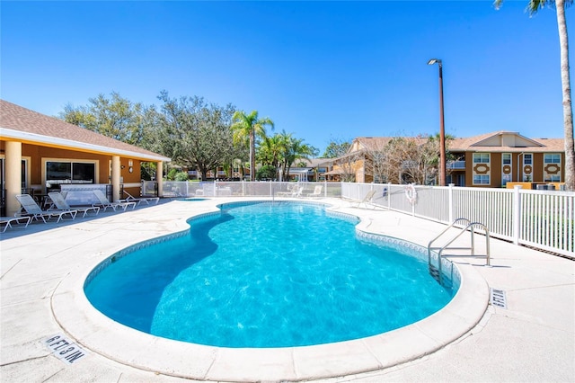 pool featuring a patio area and fence