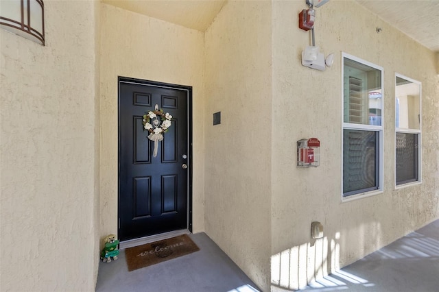 doorway to property with stucco siding