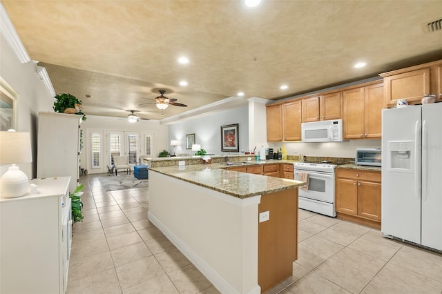 kitchen with white appliances, a peninsula, light tile patterned flooring, recessed lighting, and a sink