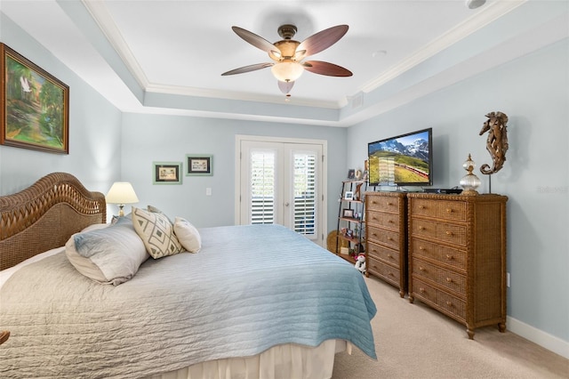 bedroom featuring light colored carpet, ornamental molding, a tray ceiling, and access to outside