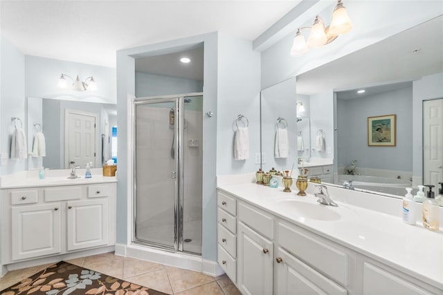 bathroom featuring tile patterned floors, a shower stall, two vanities, and a sink