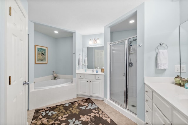 bathroom with tile patterned floors, two vanities, a sink, a shower stall, and a bath