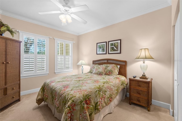 carpeted bedroom featuring baseboards, ornamental molding, and a ceiling fan