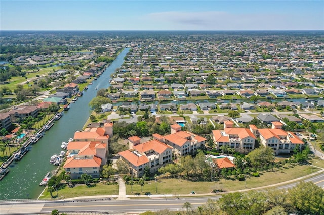 drone / aerial view with a residential view and a water view