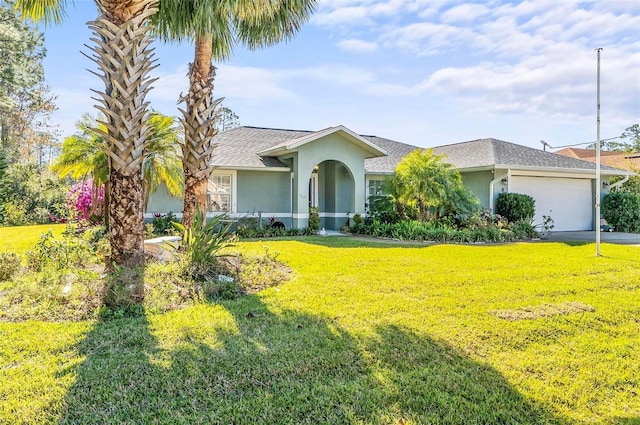 ranch-style home featuring stucco siding, driveway, a front yard, a shingled roof, and a garage