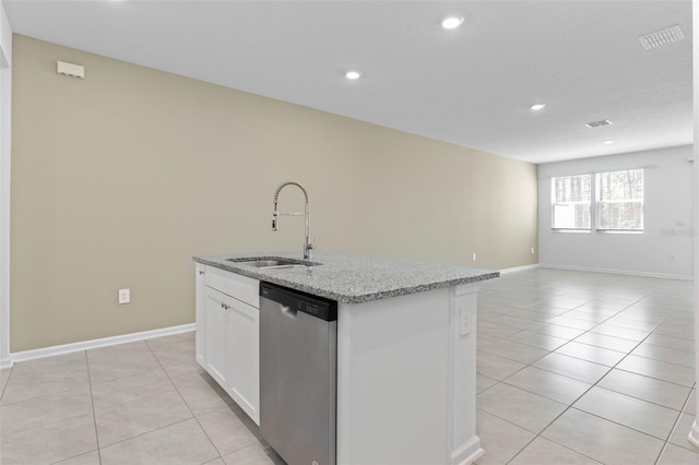 kitchen with a sink, light stone counters, stainless steel dishwasher, white cabinetry, and light tile patterned flooring