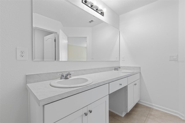 full bath featuring a sink, visible vents, double vanity, and tile patterned floors