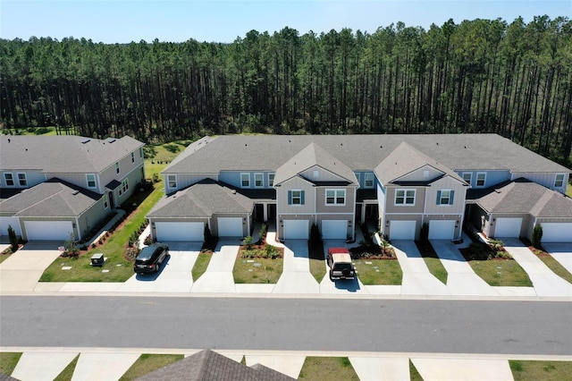 aerial view featuring a forest view and a residential view