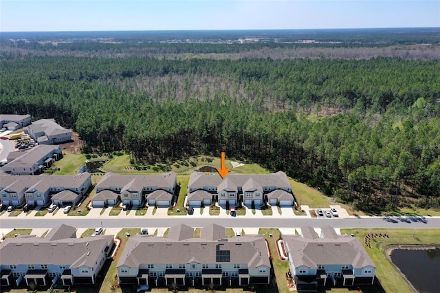 birds eye view of property with a residential view and a wooded view