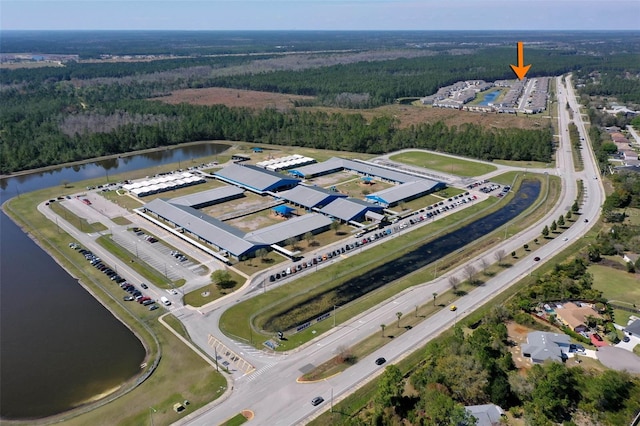 aerial view with a water view and a wooded view