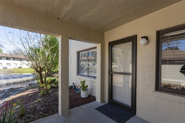 entrance to property with stucco siding