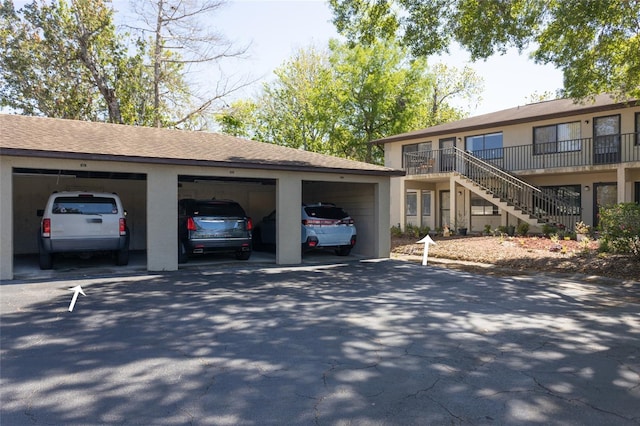 view of front of home with stairs and roof with shingles