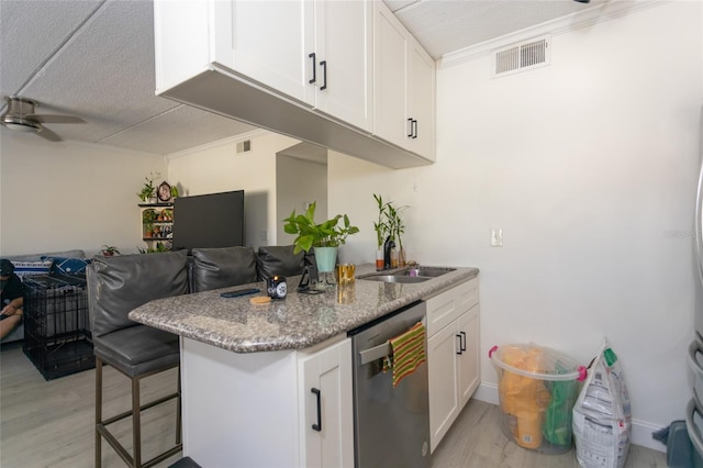 kitchen with visible vents, white cabinetry, ceiling fan, stainless steel dishwasher, and open floor plan