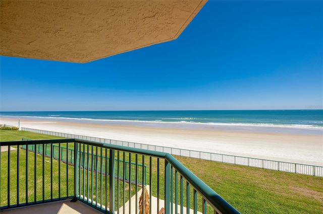 balcony featuring a water view and a view of the beach