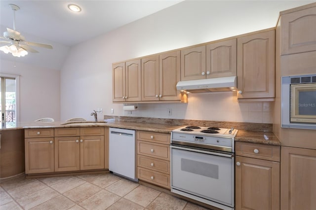 kitchen with under cabinet range hood, white appliances, light brown cabinets, and a sink