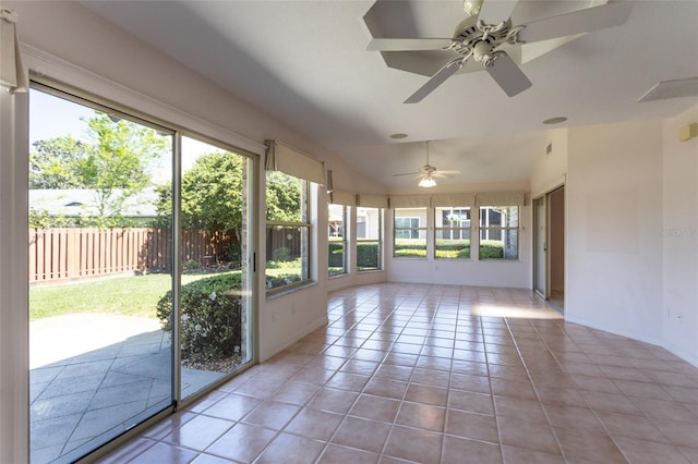 unfurnished sunroom with visible vents, a ceiling fan, and vaulted ceiling