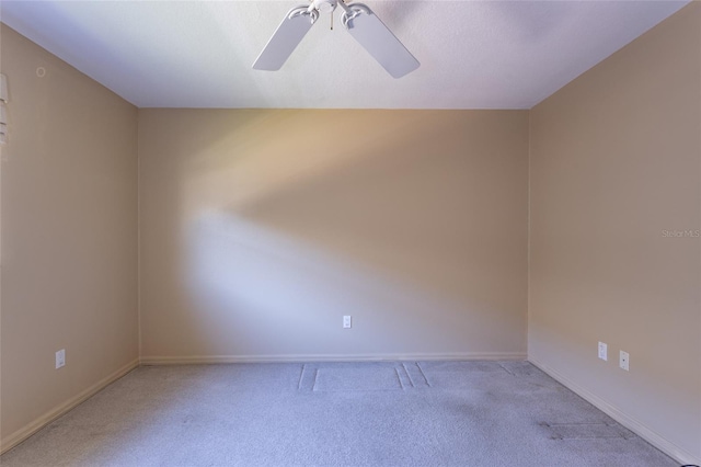 spare room with baseboards, carpet floors, and ceiling fan