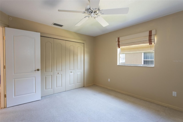 unfurnished bedroom with visible vents, baseboards, carpet flooring, a closet, and a ceiling fan